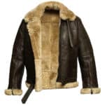 A brown leather aviator jacket with a fluffy shearling collar and lining. The jacket has two front pockets, a belted waist, and ribbed cuffs.