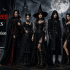 Dark gothic fashion banner featuring a model in a Victorian-style black cloak and elegant dark outfit, styled with dramatic lighting. The design showcases Fiesta Fashion branding with the website [www.fiestaafashion.com](http://www.fiestaafashion.com), highlighting a gothic clothing collection in a moody, aesthetic setting.